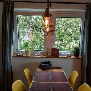 维尔茨堡stilvolle Wohnung direkt in der City的餐桌、黄色椅子和窗户