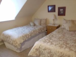 霍巴特Josie's Cottage的一间卧室配有两张床和床头灯。