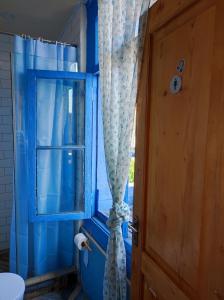 第比利斯Hostel ERA的蓝色的浴室设有窗户和窗帘