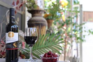 Or ‘Aqīvāhסוויטה מפוארת 800 מטר מהים קיסריה的一瓶葡萄酒,旁边是一杯红葡萄酒