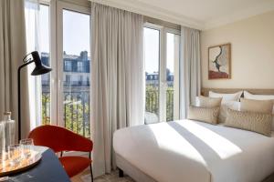 巴黎Alberte Hôtel的酒店客房设有一张床和一个大窗户