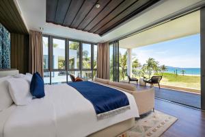 岘港Danang Ocean Resort & Spa Non Nuoc Beach Villas的一间卧室设有一张大床,享有海景