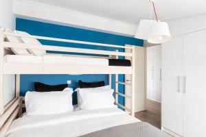 雅典Glyfada Luxury Living的一间卧室配有带蓝色墙面的双层床