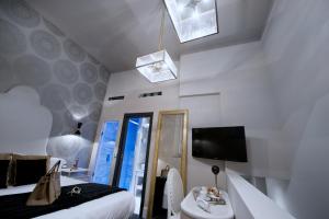 罗马罗马HT6酒店的一间卧室配有一张床、镜子和电视