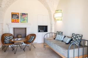 奥斯图尼Masseria Santo Scalone的客厅配有沙发、椅子和桌子