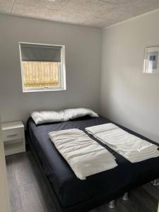 斯卡恩Fin ny moderniseret lejlighed i Skagen.的一张床上有两个枕头的房间