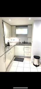 伦敦New Beautiful Lux Apartment的厨房配有白色橱柜和水槽