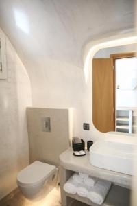 安坡里奥圣托里尼Luxury Canava的白色的浴室设有水槽和卫生间。