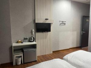 台南铁道大饭店的一间酒店客房,内设一张床和一台电视机
