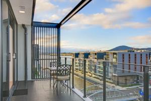 堪培拉Dockside Apartments Kingston ACT的设有一个配有桌椅并享有美景的阳台。