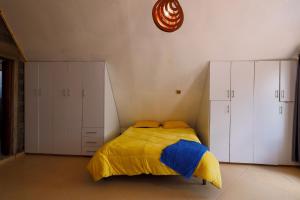 安博塞利Amboseli Cultural Camping的一间卧室配有一张黄色和蓝色毯子的床