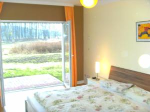 韦森贝格Ferienwohnung am Heegesee的一间卧室设有一张床和一个大窗户