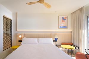 卡拉费尔Akquaaa Boutique Hotel的卧室配有白色的床和吊扇