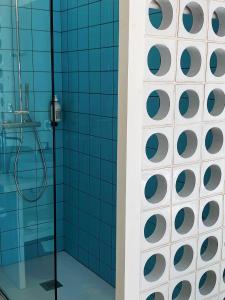 耶尔彭迪艾尔酒店的浴室设有蓝色瓷砖淋浴。