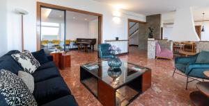 马塔罗Catalunya Casas Seafront bliss for 16 people 40km to Barcelona!的客厅配有蓝色的沙发和玻璃桌
