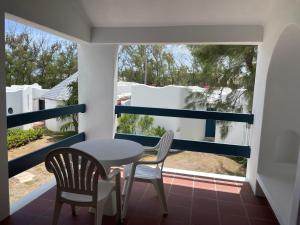 基督教堂市OceanBlue Resort的阳台配有桌椅和窗户。