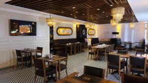 伊斯坦布尔Emirtimes Hotel&Spa - Tuzla的一间在房间内配有桌椅的餐厅