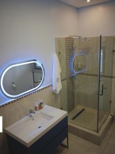 希亚丰加Villa Anastasia的带淋浴、盥洗盆和镜子的浴室