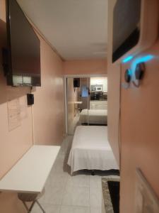 黎明城Tiny Efficiency All-In-1的小房间设有床铺和电视