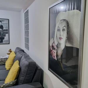布卡拉曼加Ardival apartment - WAIWA HOST的一张沙发旁墙上的女人的照片