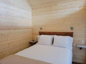 瓦莱081 Tiny Home nr Grand Canyon South Rim Sleeps 8的木制客房内的一间白色床卧室