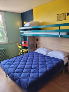 达迪利Premiere Classe Lyon Nord Dardilly的配有双层床的客房内的一张蓝色的床