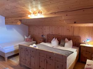 瑟尔Au Alm的木制客房内的一间卧室配有两张床