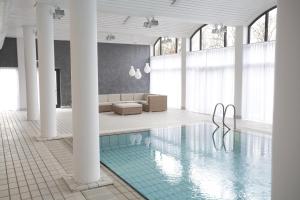 科灵卡姆维尔克尔丁酒店的客房设有带沙发和椅子的游泳池。