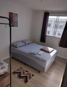 蓬塔格罗萨Apartamento novo wi-fi + TV的窗户客房内的一张床位