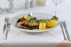 塔勒弗莱乐格林莱恩假日酒店的桌上的一盘鱼和蔬菜