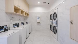 印西Toyoko Inn Imba Nihon-idai Ekimae的白色洗衣房配有水槽和洗衣机