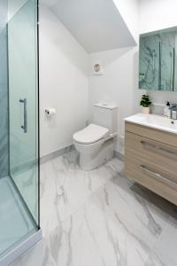 基督城The Tranquil Terrace - Zen zone 2 bed 2 bath的白色的浴室设有卫生间和玻璃淋浴间。