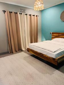 阿鲁沙City Retreat Arusha的一间卧室配有一张床和一个吊灯