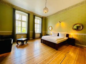 柏林花园生活 - 精品酒店的绿色卧室配有床和桌子