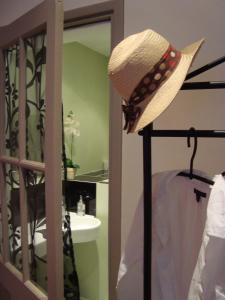 莱萨布勒-多洛讷Maison l'épicurienne的浴室旁的杆子上挂着一顶草帽