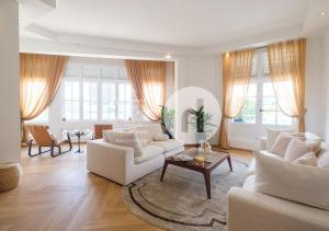 新加坡hovoh homes Bugis Rochor的客厅配有2张白色沙发和1张桌子