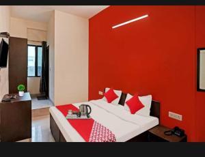 巴特那Flagship Hotel Heaven的一间卧室配有一张红色墙壁的床