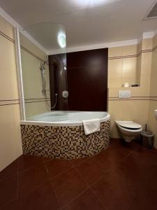 皮耶什佳尼City Hotel的带浴缸和卫生间的浴室。