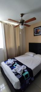 蒙特内哥罗Apartamento muy cerca al Parque del Café con Piscina - Montenegro 101A的一间卧室配有一张带吊扇的床