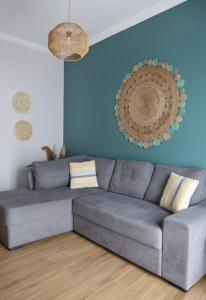 锡蒂亚Sitia Cozy Apartment的客厅里设有一张灰色沙发,拥有蓝色的墙壁