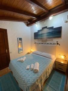 穆拉沃拉L'Uliveto HOLIDAY HOUSE -Casa Vacanze Indipendente-的一间卧室配有带毛巾的床