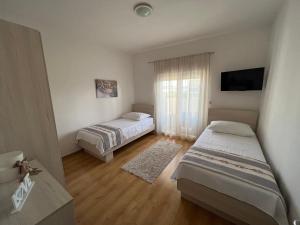 苏科尚Apartman Burčul的一间设有两张床和电视的房间