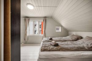卑尔根Dinbnb Homes I 4-Bedroom Historical House in Romantic Surroundings的一间卧室设有两张床和窗户。