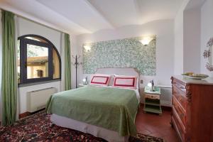 蒙泰斯佩尔托利Villa I Leoni的一间卧室配有一张床、一个梳妆台和一扇窗户。