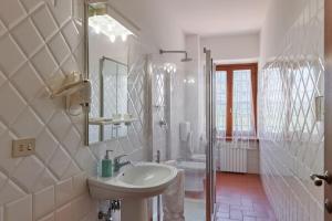 蒙泰斯佩尔托利Villa I Leoni的白色的浴室设有水槽和淋浴。