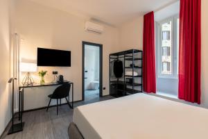 罗马Residenza Sacconi的一间卧室配有一张带红色窗帘的床和一张书桌