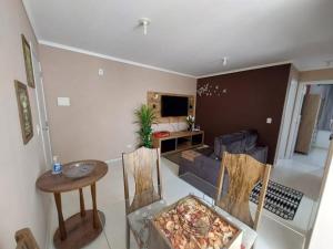 乌尼昂-达维多利亚Apartamento inteiro com garagem coberta的客厅配有沙发和桌椅