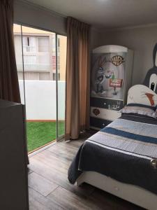 利马Hermoso Duplex en Chorrillos的一间卧室设有一张床和一个大窗户