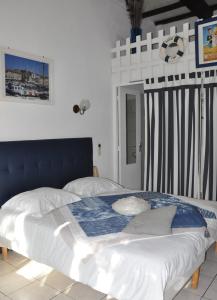 博尔马斯·莱斯·米默萨斯莱斯米默萨斯酒店的一间卧室配有一张大床和蓝色床头板