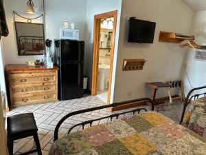 博尼塔斯普林斯水牛城牧场汽车旅馆的客厅配有床和黑冰箱